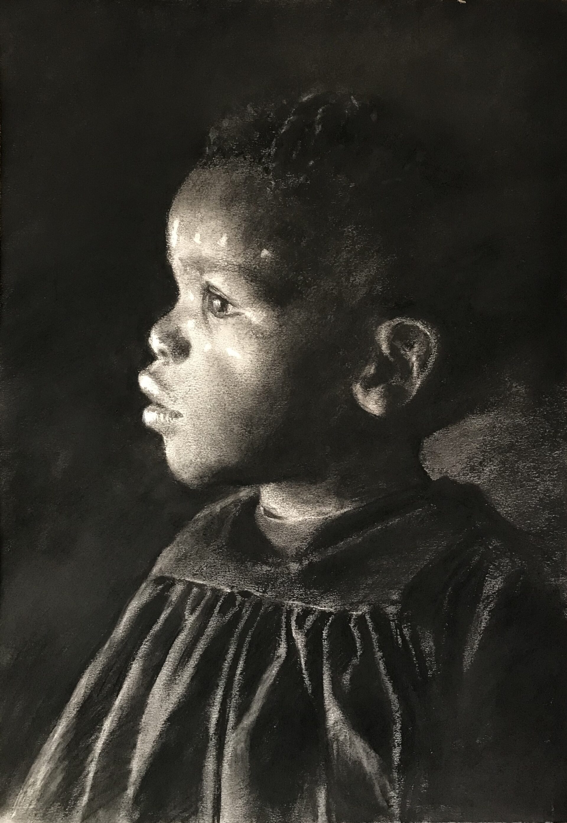 A charcoal drawing of a young African girl wearing a dark smocked dress, the light falling on her face